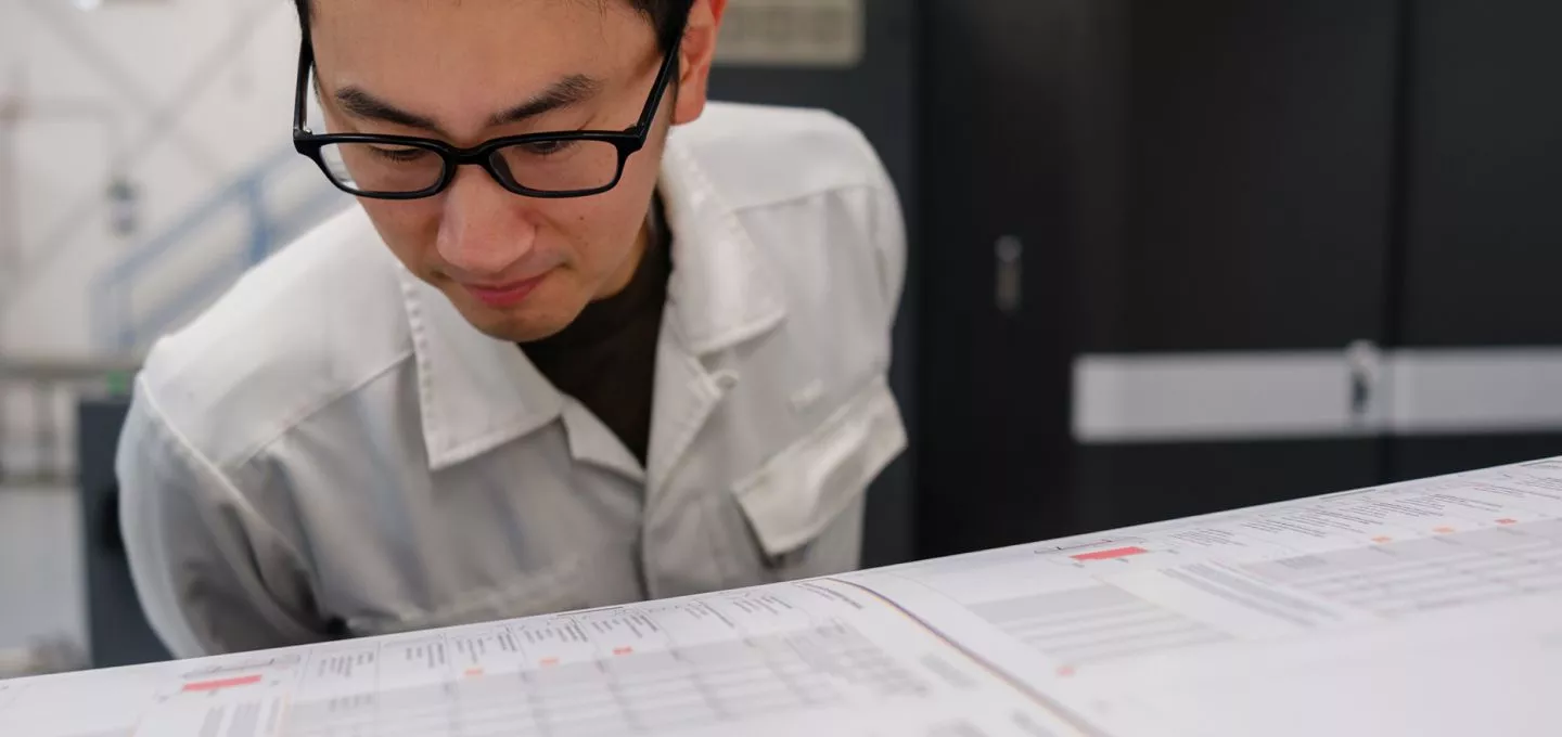 Person looking at a paper sheet